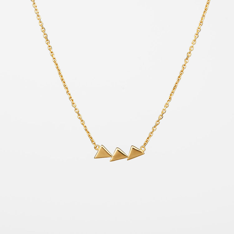 A gold-colored necklace featuring three geometric triangle pendants.