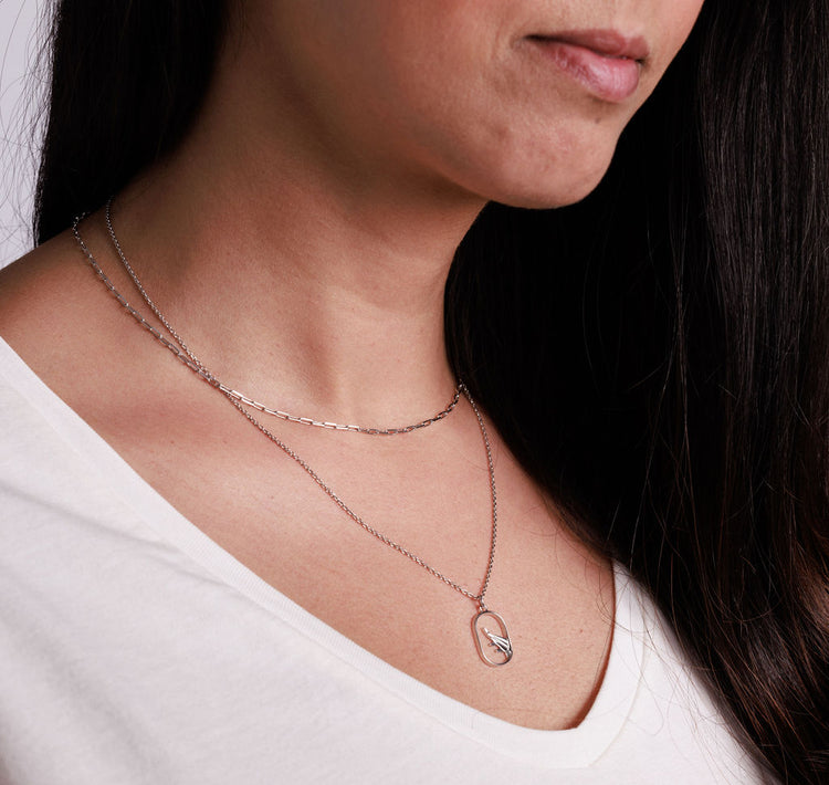 Silver paperclip chain and airplane necklace stacked