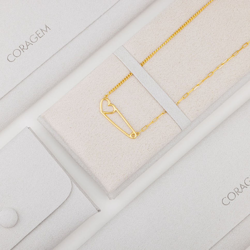 gold heart necklace in grey jewelry case