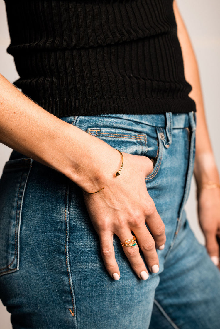 gold cuff bracelet on model wearing jeans