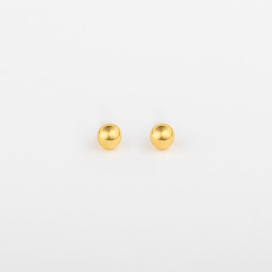 A pair of gold ball stud earrings on a white background.
