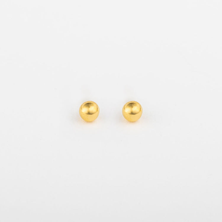 A pair of gold ball stud earrings on a white background.
