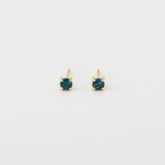 A pair of gold vermeil stud earrings featuring round london blue topaz gemstones
