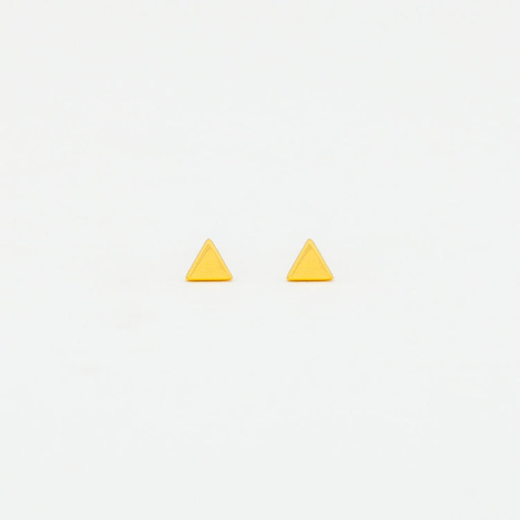 A pair of yellow gold vermeil triangle stud earrings on a white background.