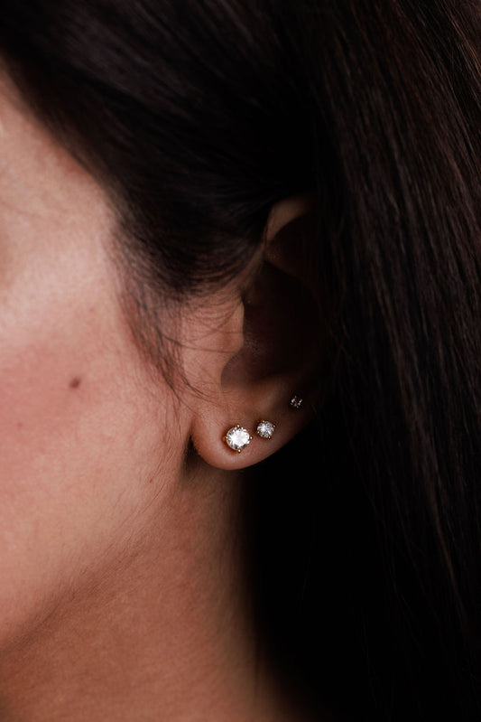 White topaz studs stacked on ear