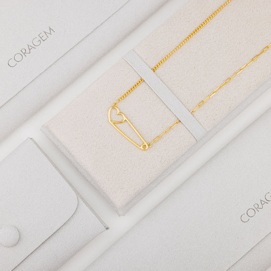 gold heart necklace in grey jewelry case