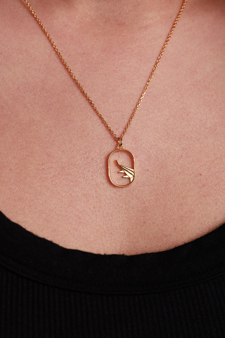 gold airplane necklace on gold chain 