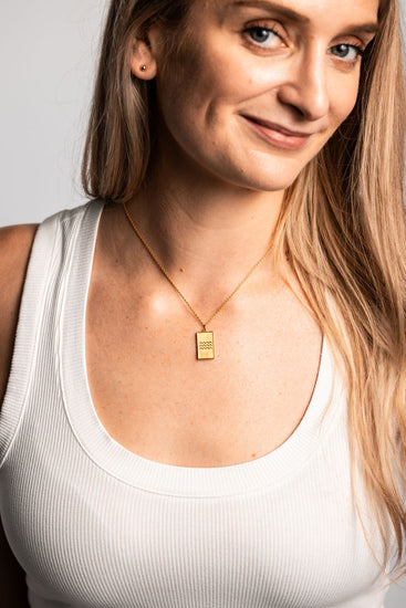 gold stud earring with ocean wave necklace