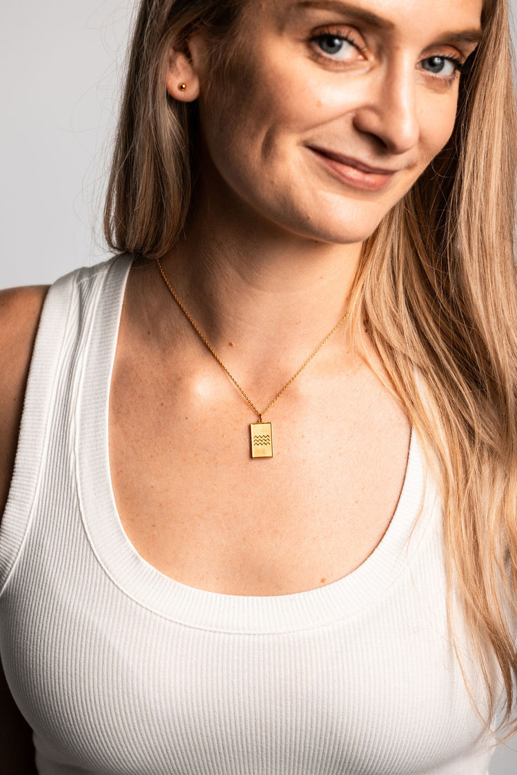 gold stud earring with ocean wave necklace