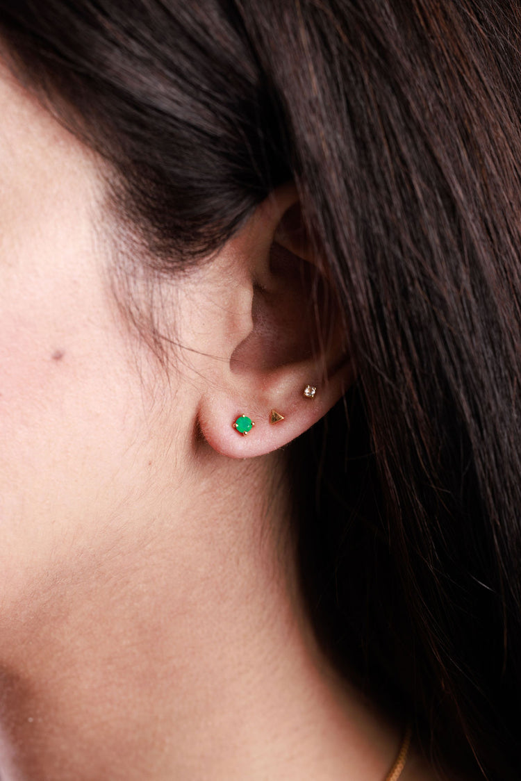 Dainty green onyx stud earrings paired with other stud earrings
